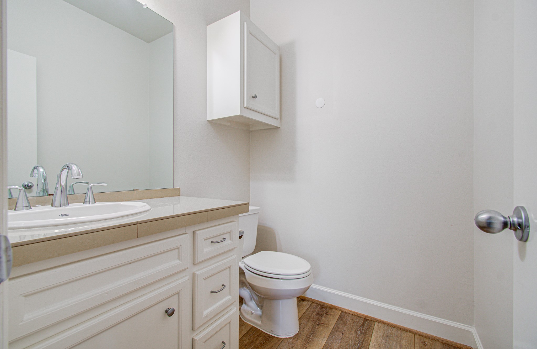 624 East 39th Street Houston, TX 77022 - Photo 18 of 37 a bathroom with a granite countertop toilet a sink and a mirror