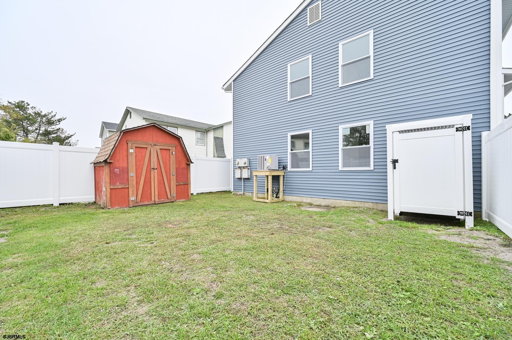 12 Lighthouse Drive, Unit A Brigantine, NJ 08203 - Photo 14 of 16 a backyard of a house with table and chairs