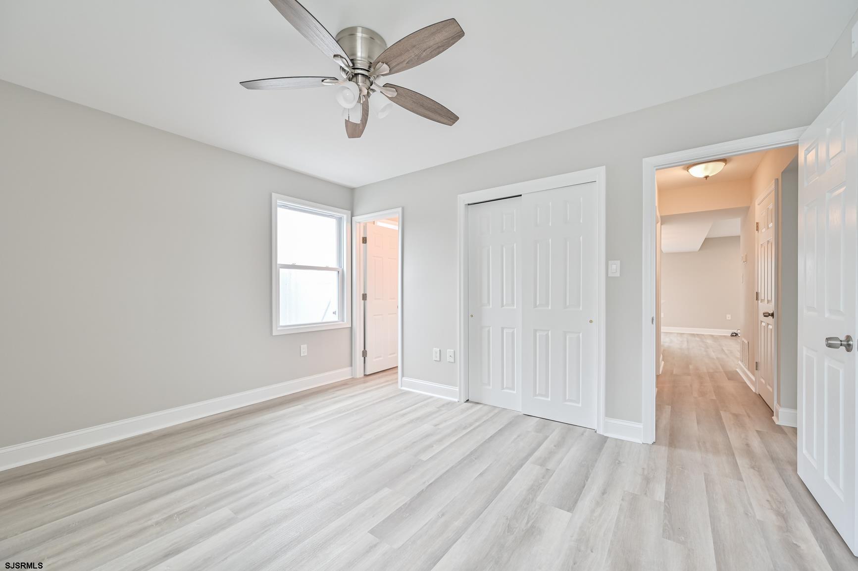 12 Lighthouse Drive, Unit A Brigantine, NJ 08203 - Photo 6 of 16 wooden floor in an empty room with a window