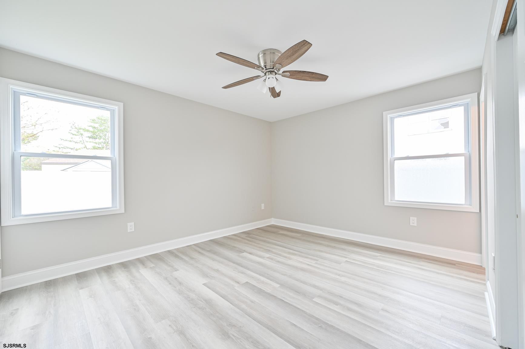 12 Lighthouse Drive, Unit A Brigantine, NJ 08203 - Photo 8 of 16 wooden floor in an empty room with a window
