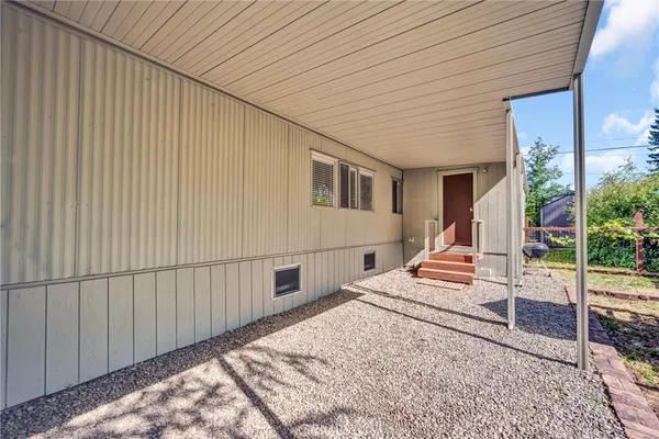 a view of a house with backyard and wooden fence