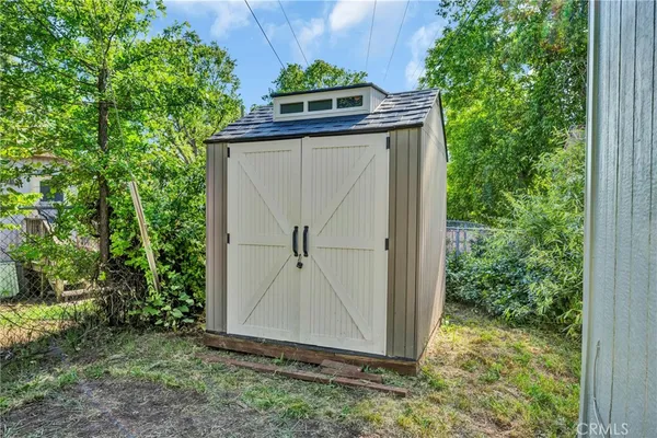 a view of a garage with a tree