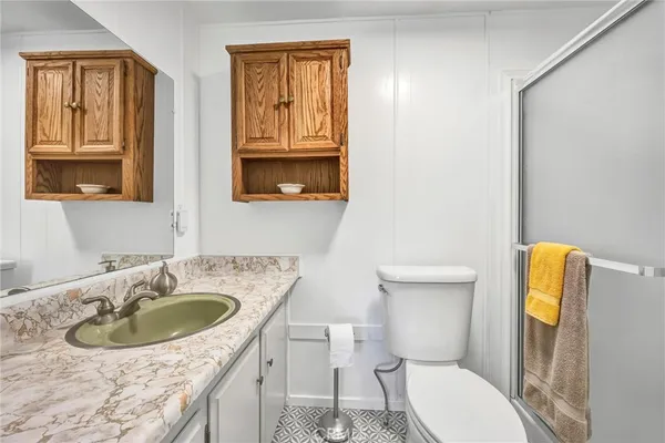 a bathroom with a sink a toilet and mirror