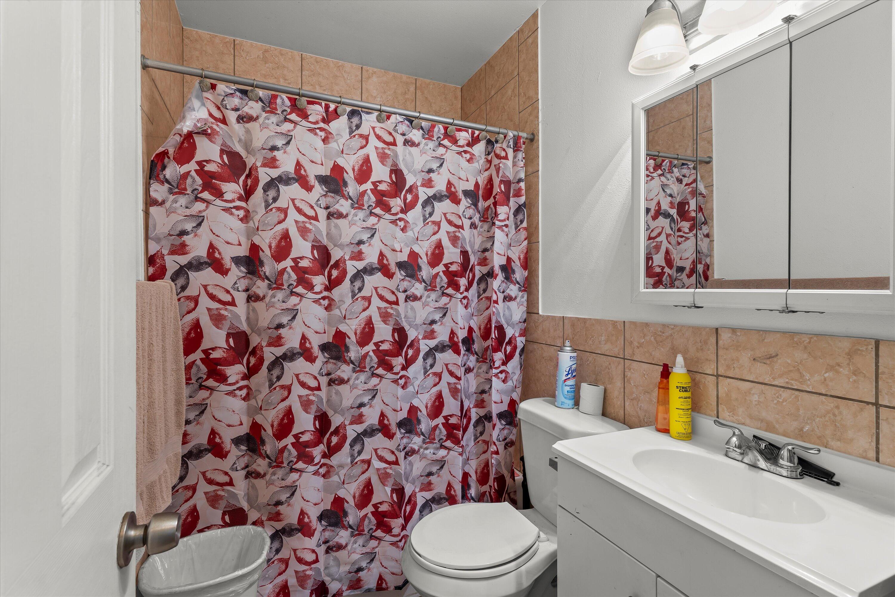 2222 22nd Street Lubbock, TX 79411 - Photo 11 of 16 a bathroom with a toilet and a sink