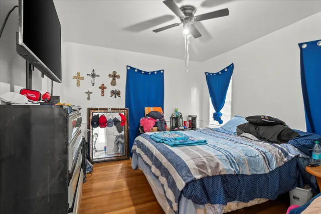 a bedroom with bed and a chandelier