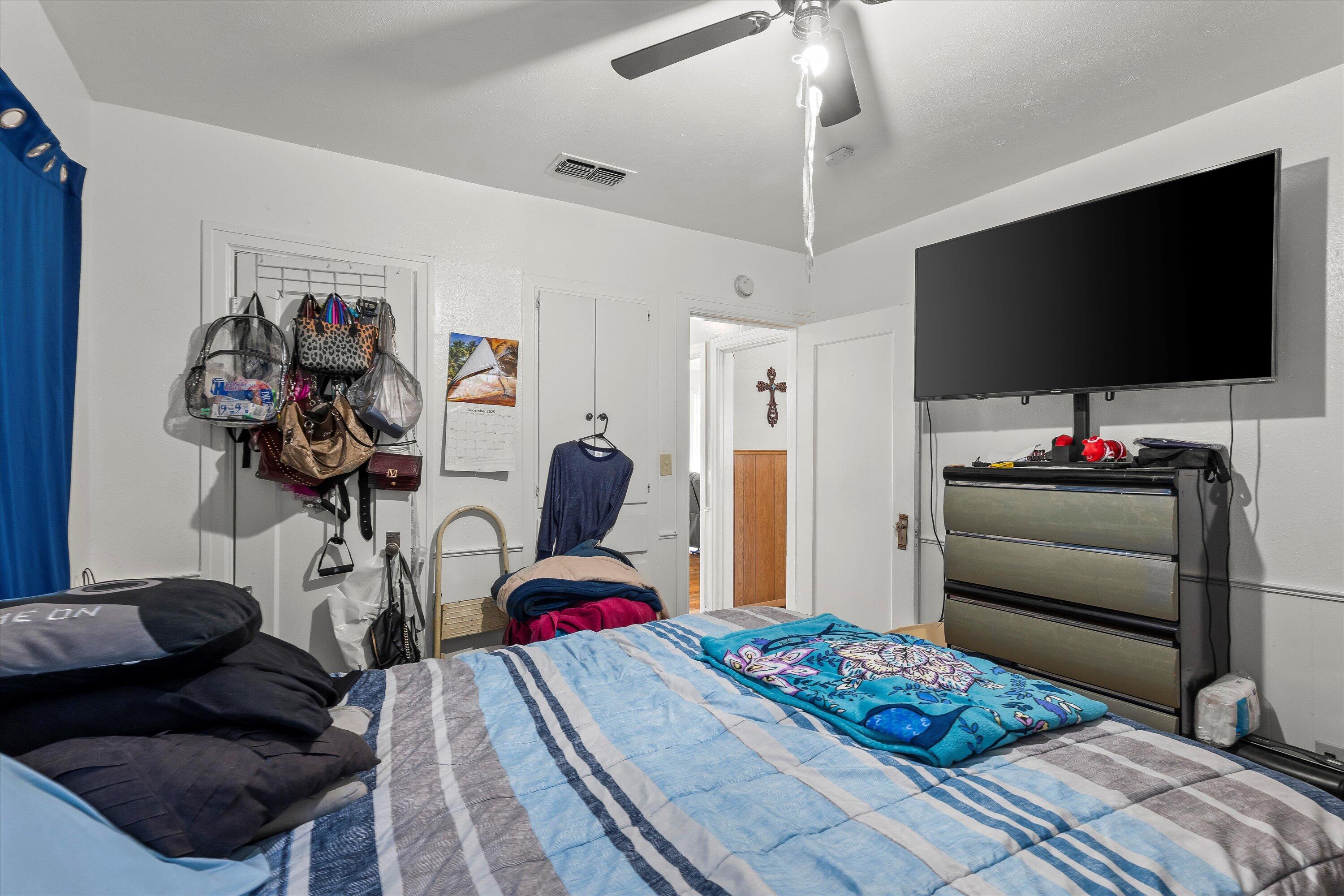 2222 22nd Street Lubbock, TX 79411 - Photo 13 of 16 a bedroom with a bed and a flat screen tv