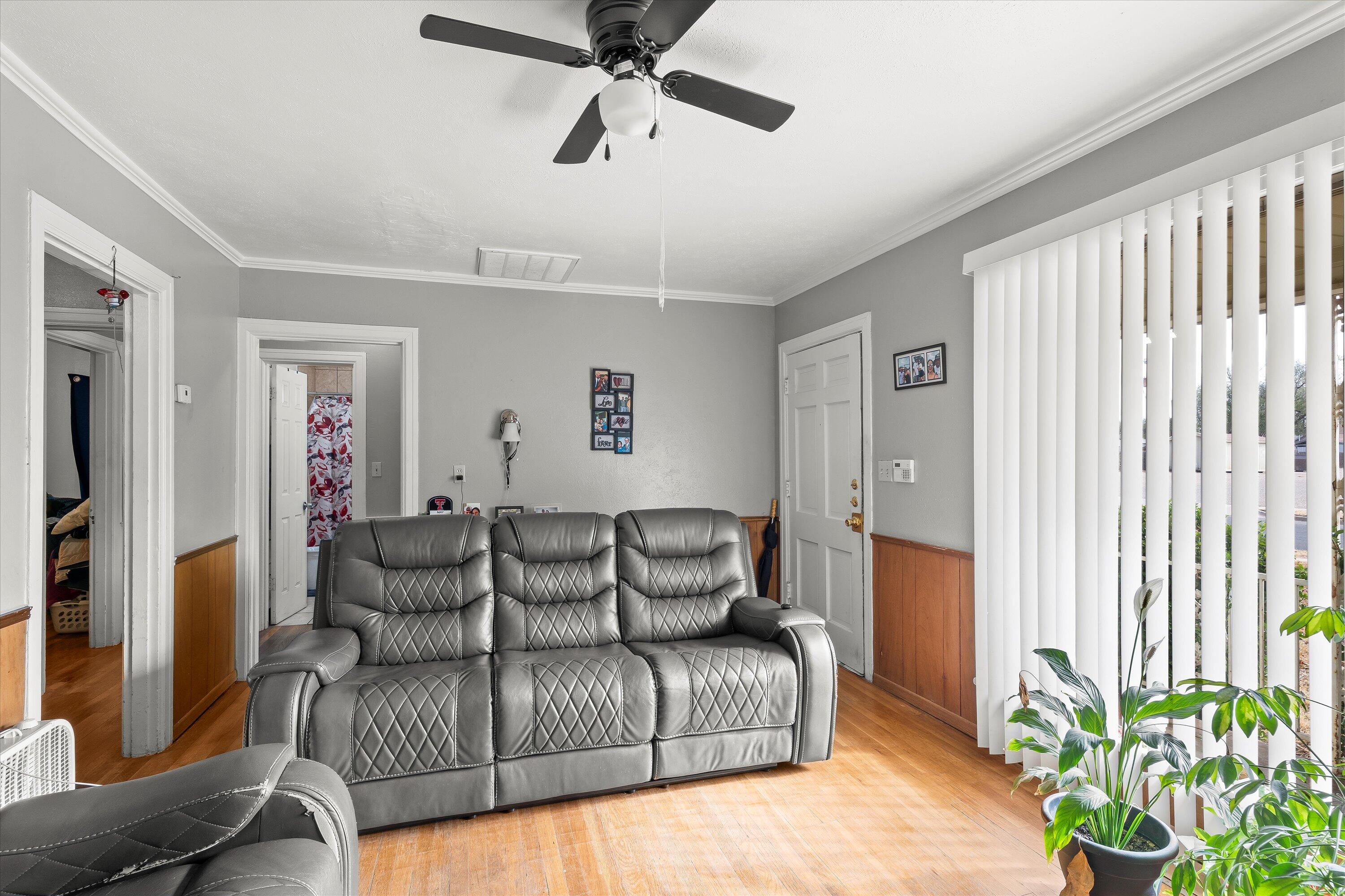 2222 22nd Street Lubbock, TX 79411 - Photo 5 of 16 a living room with furniture and a potted plant