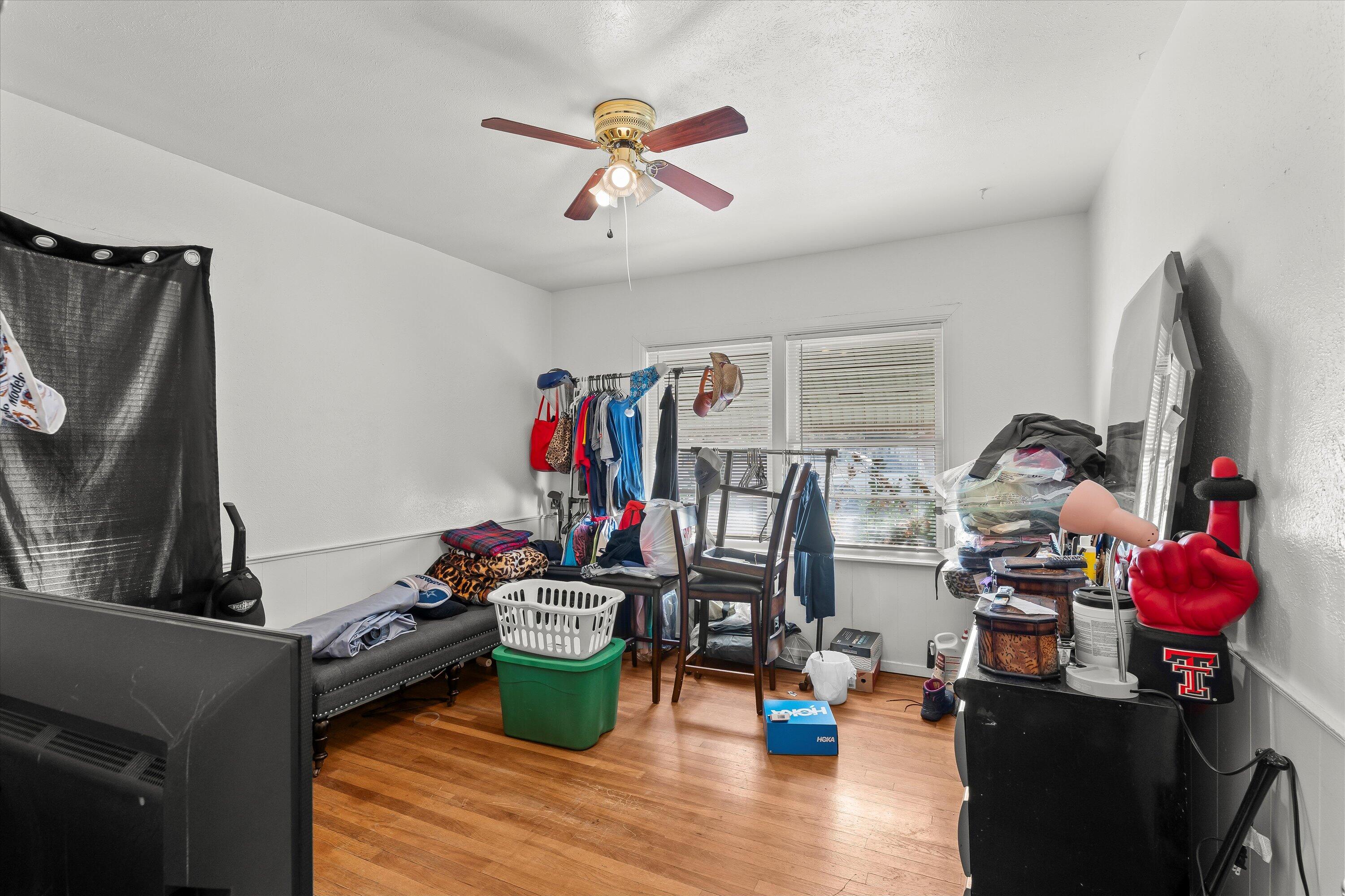2222 22nd Street Lubbock, TX 79411 - Photo 9 of 16 a view of a workspace with furniture and a flat screen tv