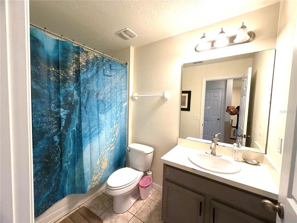 4573 Ada Lane Kissimmee, FL 34746 - Photo 16 of 37 a bathroom with a sink and a mirror