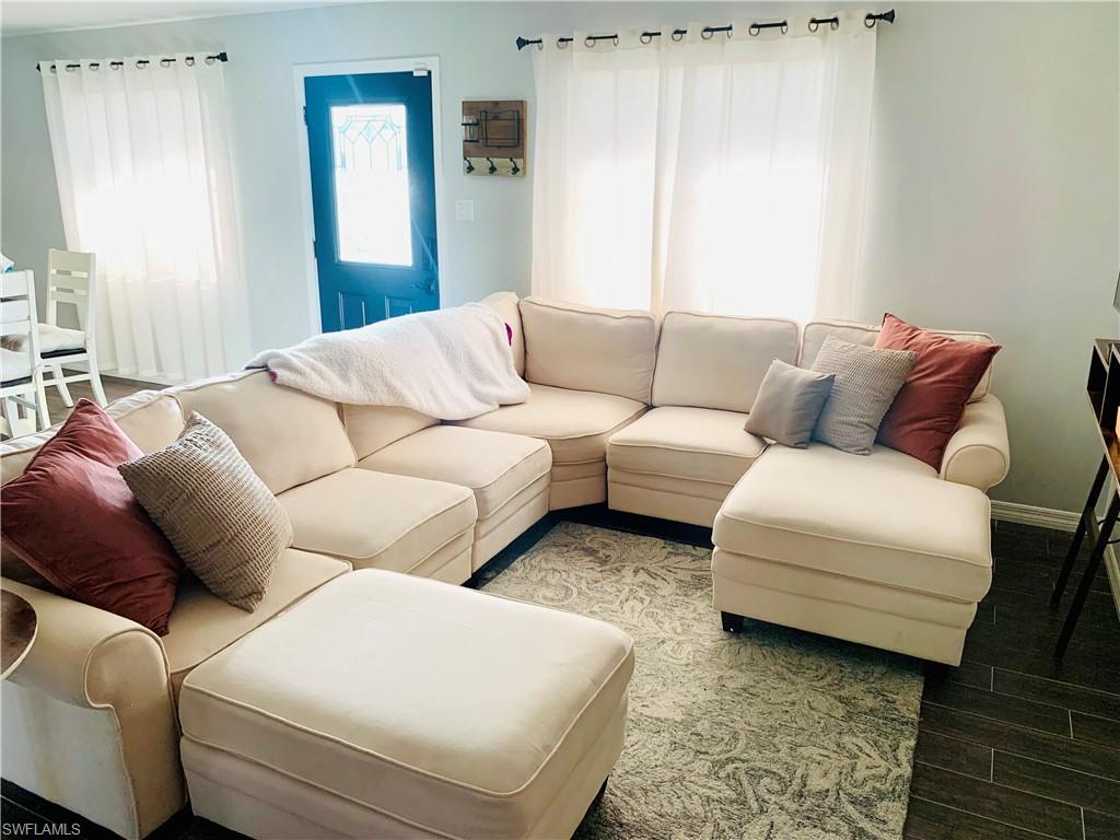 235 Cypress Way West Naples, FL 34110 - Photo 11 of 14 a living room with furniture and a couch
