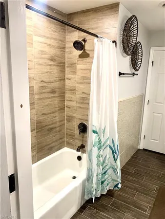 a bathroom with a tub and a shower