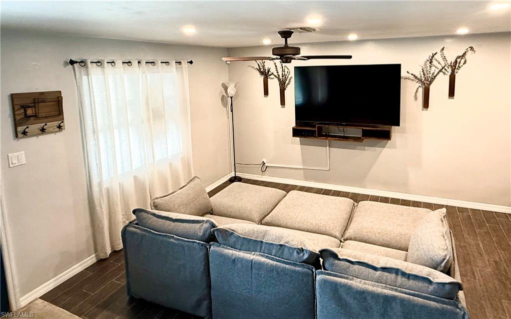 235 Cypress Way West Naples, FL 34110 - Photo 4 of 18 a living room with furniture and a flat screen tv