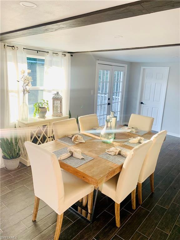 235 Cypress Way West Naples, FL 34110 - Photo 6 of 14 a view of a dining room with furniture and wooden floor