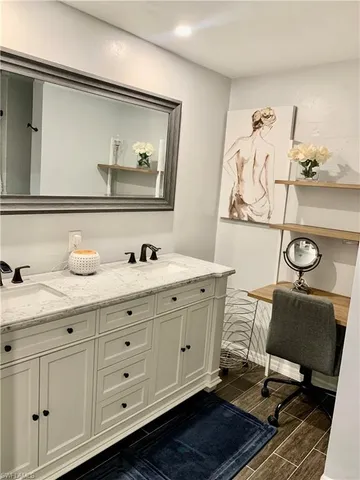 a spacious bathroom with a double vanity sink and a mirror