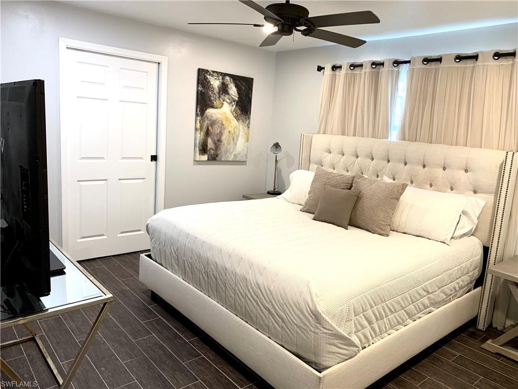 235 Cypress Way West Naples, FL 34110 - Photo 9 of 18 a bedroom with a bed and a window