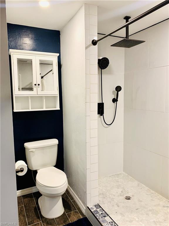 235 Cypress Way West Naples, FL 34110 - Photo 9 of 14 a bathroom with a toilet sink and shower