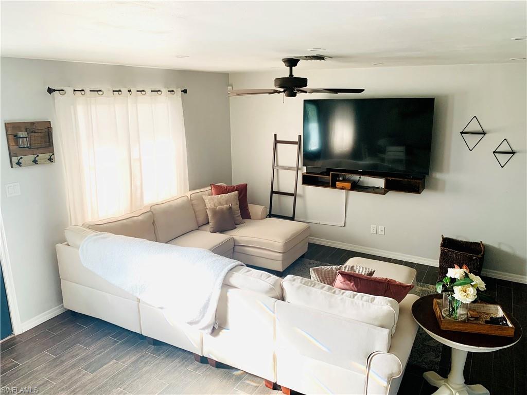 235 Cypress Way West Naples, FL 34110 - Photo 10 of 14 a living room with furniture and a flat screen tv