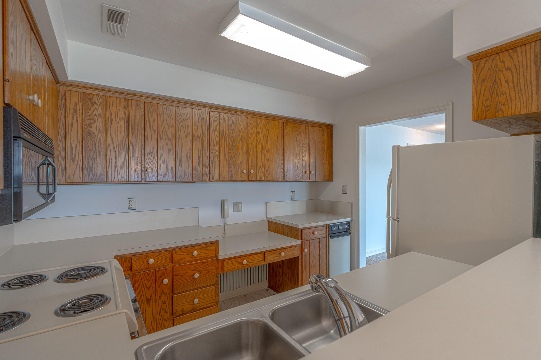 845 Gangplank Road, Unit 203 Moneta, VA 24121 - Photo 11 of 46 a kitchen with stainless steel appliances a sink a stove a refrigerator white cabinets and wooden floor