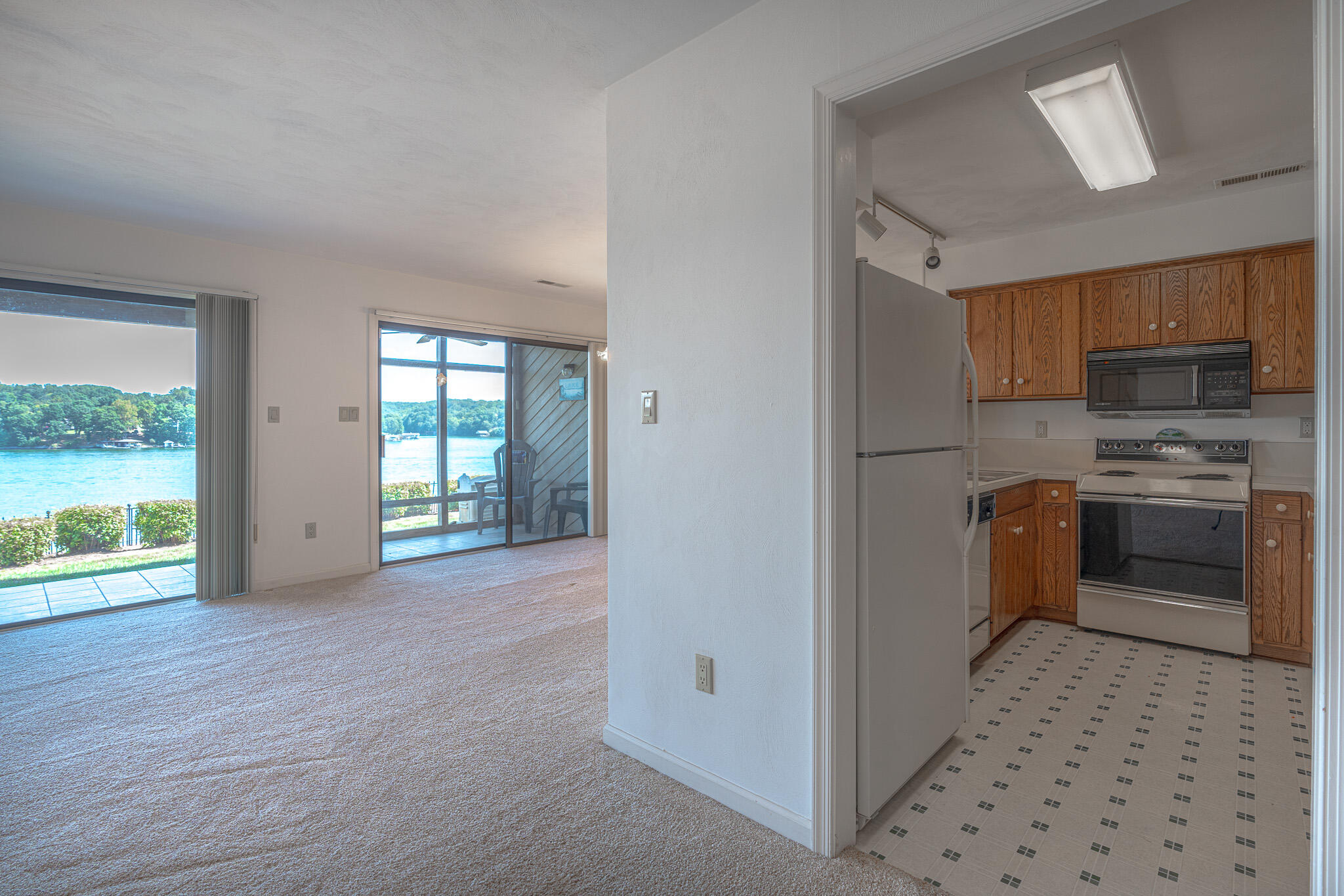 845 Gangplank Road, Unit 203 Moneta, VA 24121 - Photo 13 of 46 a kitchen with granite countertop a refrigerator and a stove