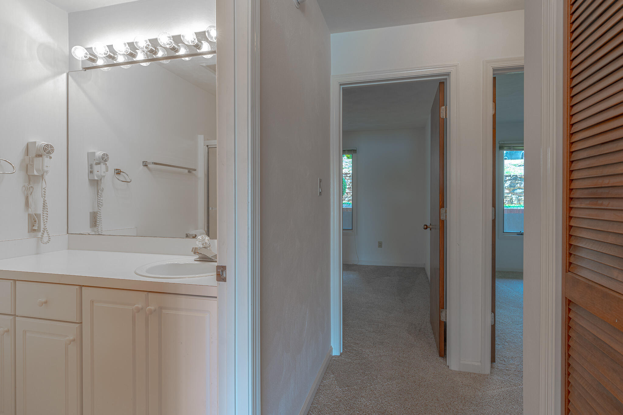 845 Gangplank Road, Unit 203 Moneta, VA 24121 - Photo 15 of 46 a bathroom with a granite countertop sink a mirror and a shower