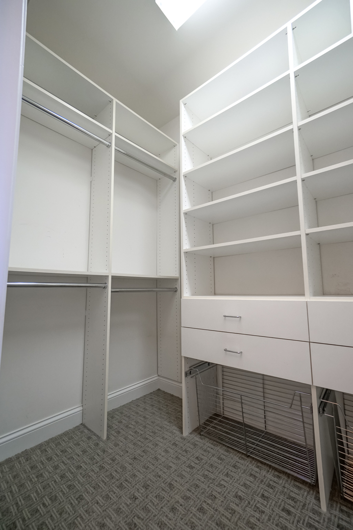620 McHenry Road, Unit 105 Wheeling, IL 60090 - Photo 14 of 20 a view of walk in closet with empty racks