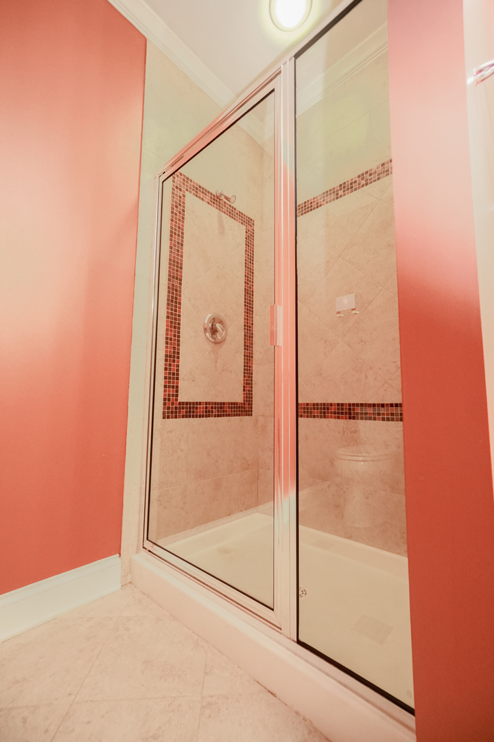 620 McHenry Road, Unit 105 Wheeling, IL 60090 - Photo 17 of 20 a bathroom with a glass shower door