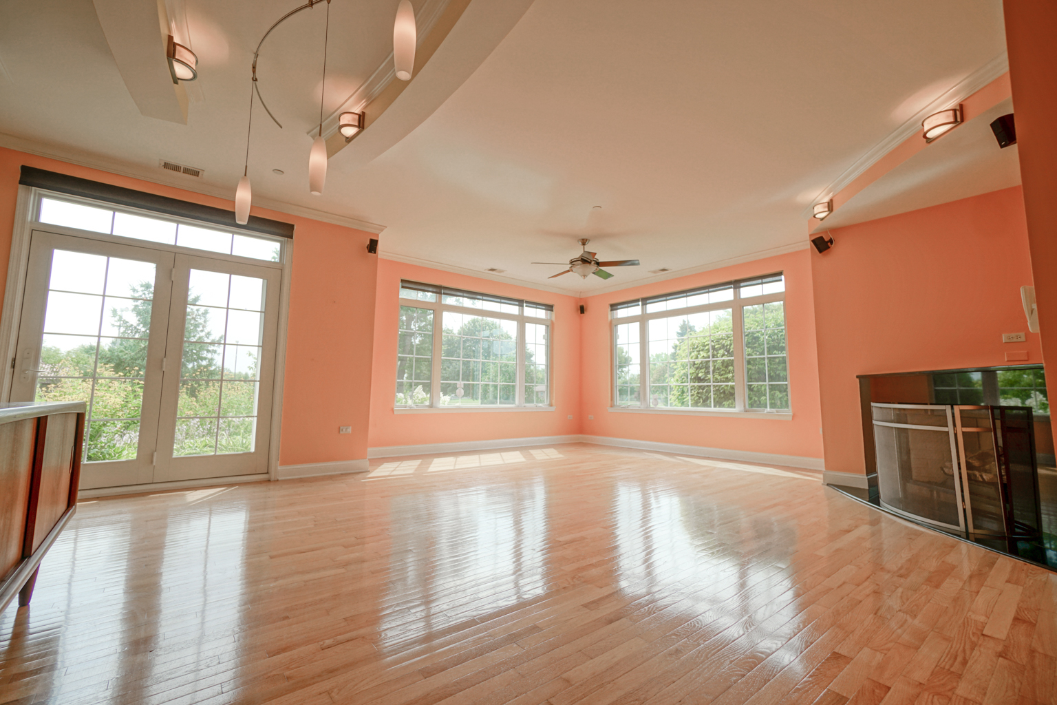 620 McHenry Road, Unit 105 Wheeling, IL 60090 - Photo 5 of 20 a view of an empty room with a window and wooden floor