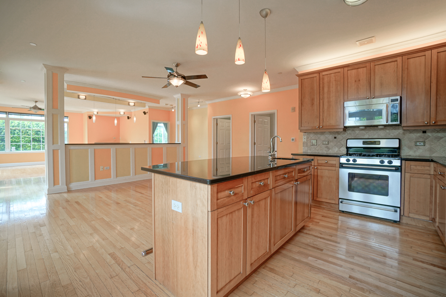 620 McHenry Road, Unit 105 Wheeling, IL 60090 - Photo 9 of 20 a kitchen with stainless steel appliances kitchen island granite countertop a stove and a sink