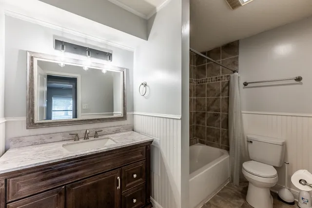 a bathroom with a sink a toilet and bathtub