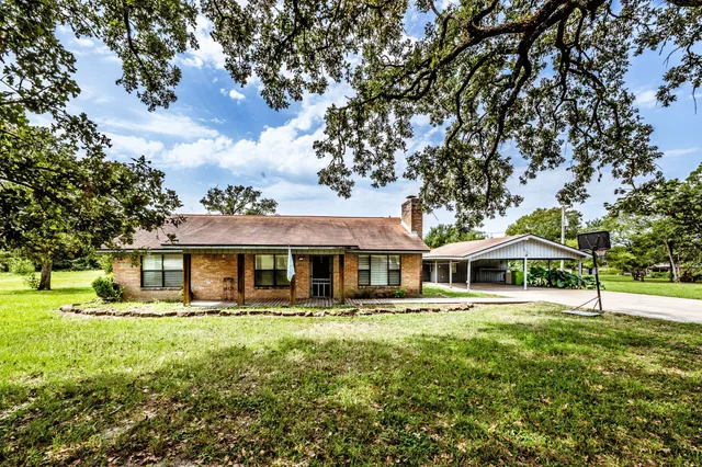 a front view of a building with garden