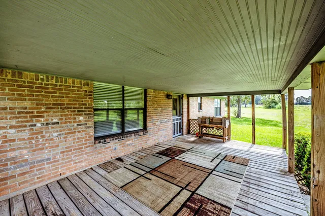 a view of a patio with wooden floor