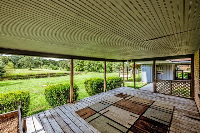 a view of a patio with wooden floor