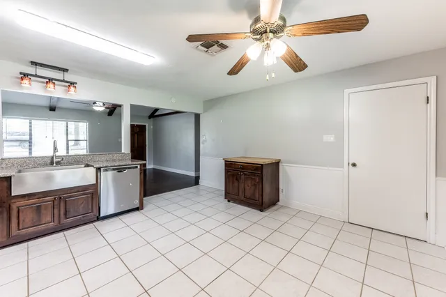 a kitchen with stainless steel appliances a sink and a refrigerator