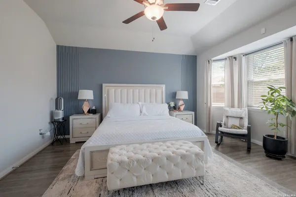 a bedroom with a bed and potted plant