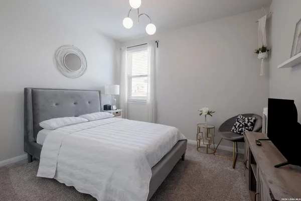 a bedroom with a bed and a window