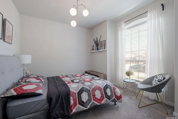 a bedroom with a bed and a chair