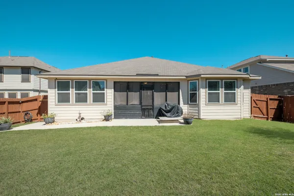 a view of a house with backyard porch and sitting area