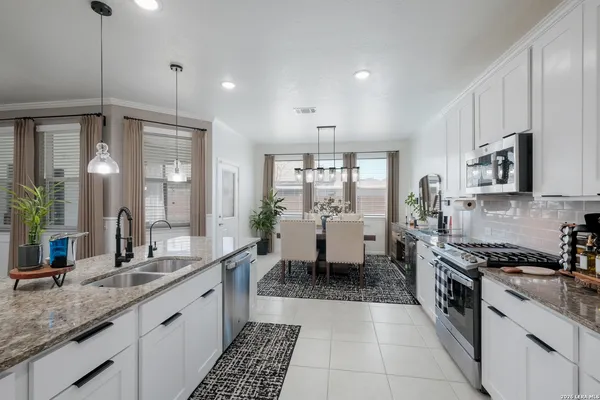 a large white kitchen with a large window