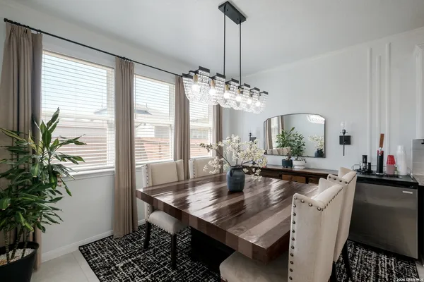 a dining room with furniture a chandelier and window