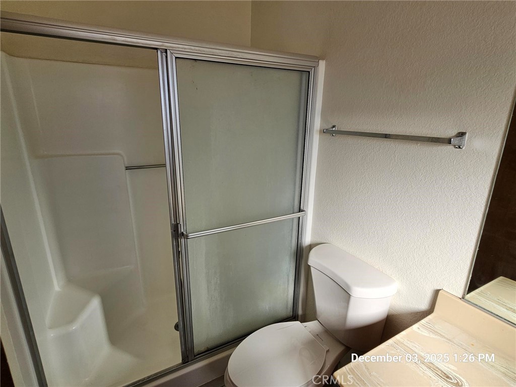 18891 Rock Springs Road Hesperia, CA 92345 - Photo 21 of 25 a white toilet sitting next to a shower