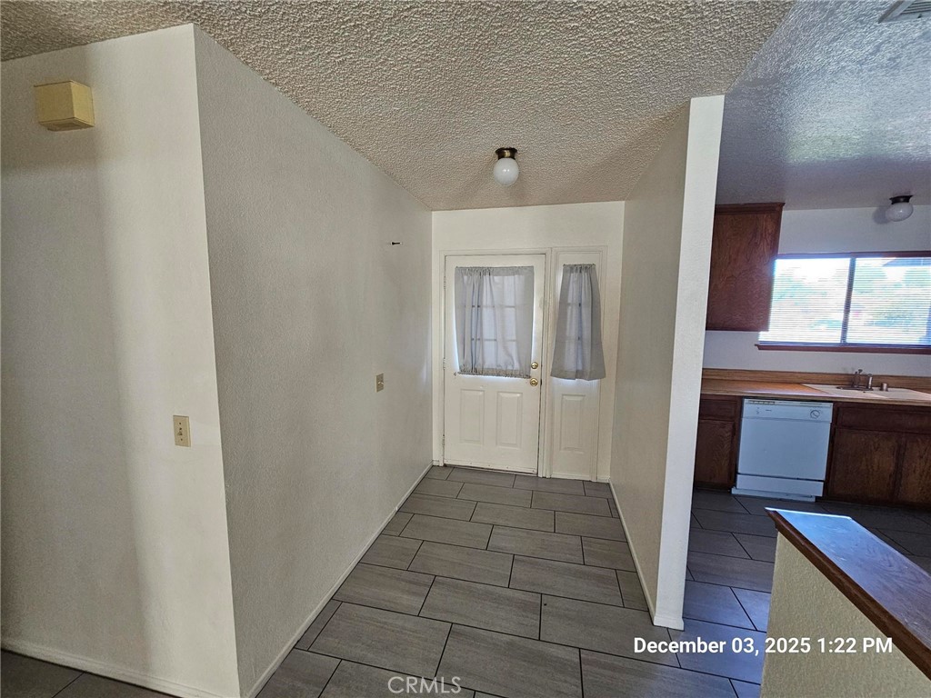 18891 Rock Springs Road Hesperia, CA 92345 - Photo 7 of 25 a view of a hallway with wooden floor and staircase