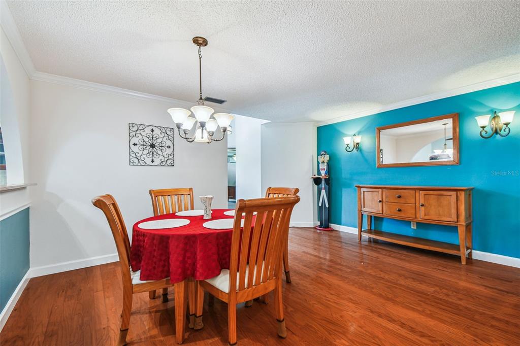 6006 Redhawk Drive New Port Richey, FL 34655 - Photo 15 of 90 a dining room with furniture a chandelier and wooden floor