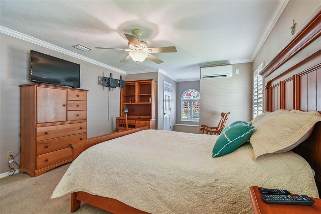 6006 Redhawk Drive New Port Richey, FL 34655 - Photo 36 of 90 a bedroom with a large bed and a flat tv screen on dresser