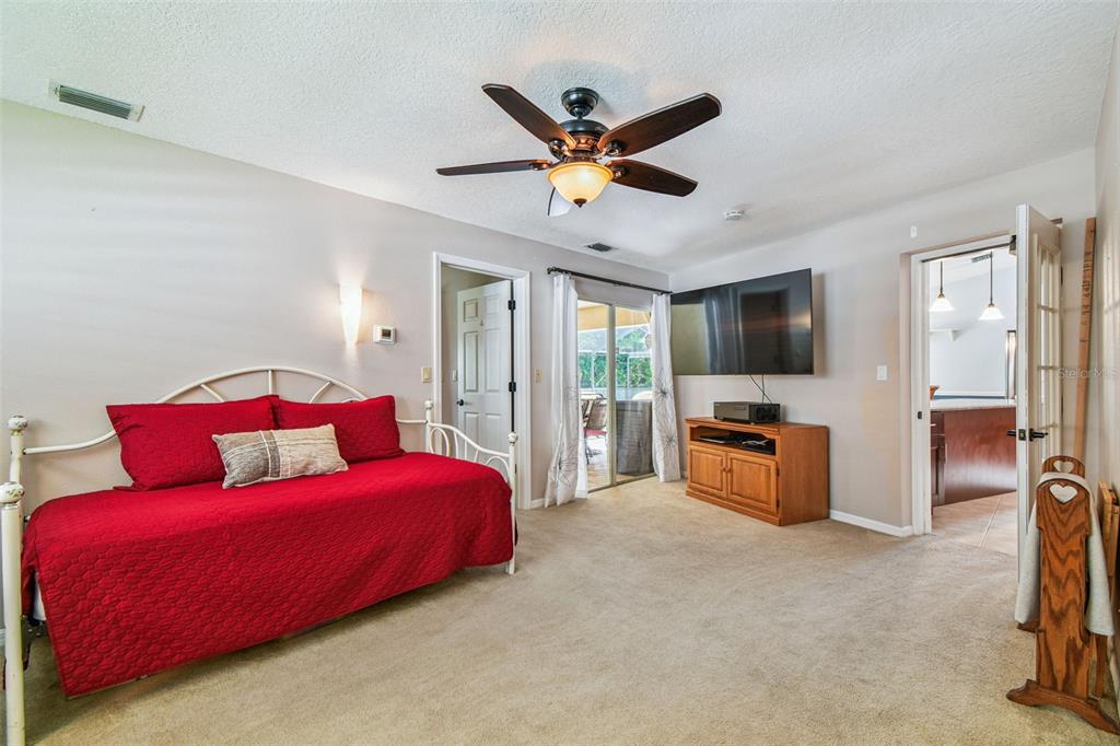 6006 Redhawk Drive New Port Richey, FL 34655 - Photo 44 of 90 a bedroom with a bed and a flat screen tv