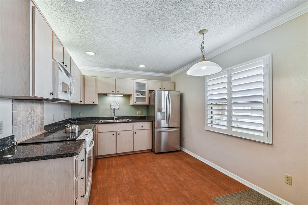 6006 Redhawk Drive New Port Richey, FL 34655 - Photo 46 of 90 a kitchen with stainless steel appliances granite countertop a stove a sink and a refrigerator