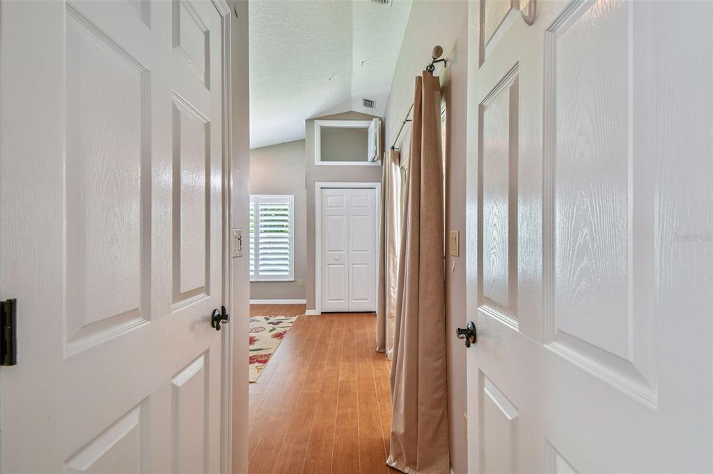 6006 Redhawk Drive New Port Richey, FL 34655 - Photo 53 of 90 a view of a hallway with wooden floor and a livingroom