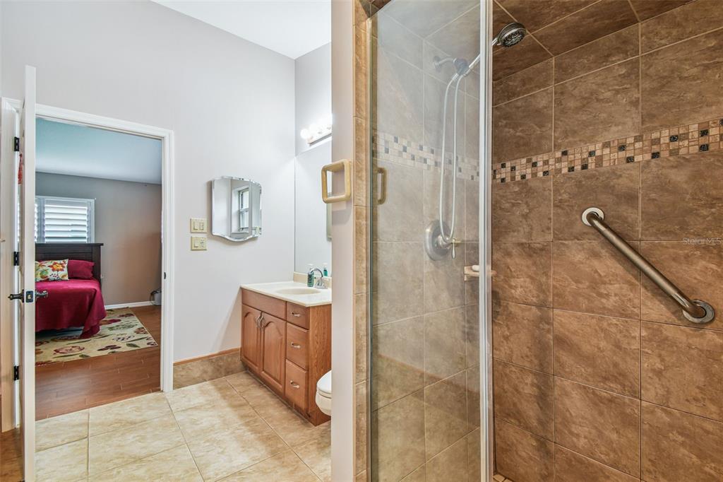 6006 Redhawk Drive New Port Richey, FL 34655 - Photo 60 of 90 a bathroom with a tub shower and mirror