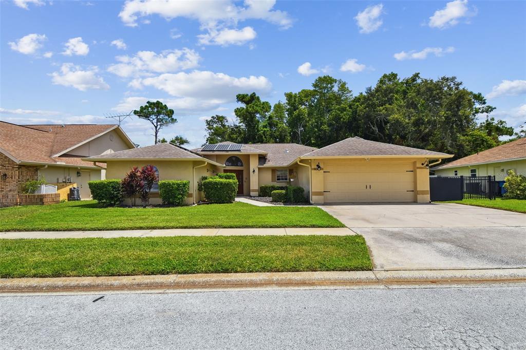 6006 Redhawk Drive New Port Richey, FL 34655 - Photo 6 of 90 a front view of a house with a yard and garage