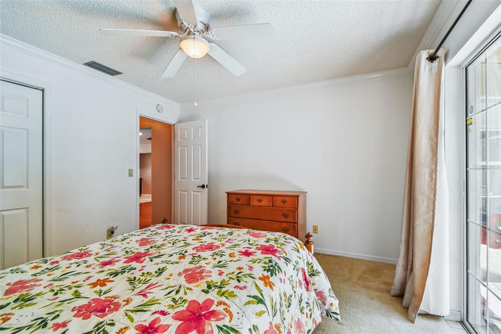 6006 Redhawk Drive New Port Richey, FL 34655 - Photo 70 of 90 a bedroom with a bed and a chandelier