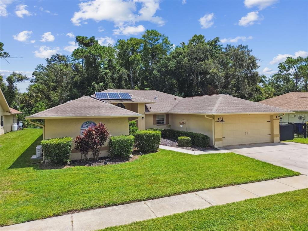 6006 Redhawk Drive New Port Richey, FL 34655 - Photo 88 of 90 a front view of a house with a yard and garage